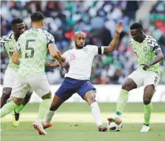  ?? AP ?? England’s Fabian Delph (centre) duels for the ball with Nigeria’s Oghenekaro Etebo (right) at Wembley Stadium.