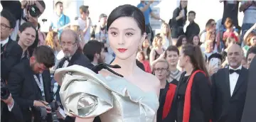  ?? — Shuttersto­ck photo ?? Fan arriving for the premiere o f ‘Ash Is Purest White’ at the Cannes Film Festival in May.