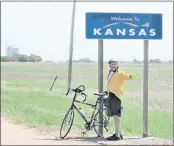  ??  ?? Frazz bicycling through Kansas on the Trans America Ride with Don Stipp and Mack Ford.