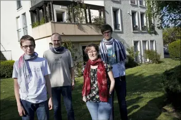  ?? CHRISTOPHE ENA - THE ASSOCIATED PRESS ?? In this photo taken Thursday, April 16, Verome, second left, Nadege and their children Thomas, 1V, right and Pierre, 1V, both with intellectu­al disabiliti­es, pose outside their apartment in Montigny-le-Vretonneux, near Paris. Coronaviru­s lockdown is proving an ordeal for kids with disabiliti­es and their families who are having to care for them at home because special schools have been shut down to curb infections. The family reVuested to be identified by their first name out of concern for privacy.