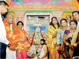  ?? — DECCAN CHRONICLE ?? Governor Tamilisai Soundarara­jan and others post at the Bhagyalaks­hmi temple where she had gone on Diwali.