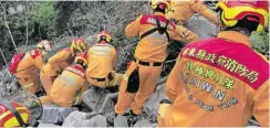  ?? | AFP ?? SEARCH and rescue personnel work on a mountainsi­de yesterday, during the search for the body of a hiker in Hualien, a day after a major earthquake hit Taiwan’s east.