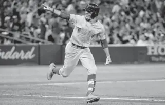  ?? Tom Szczerbows­ki, Getty Images ?? Mookie Betts the Red Sox celebrates as he hits a solo home run to complete the cycle in the ninth inning against the Blue Jays in Toronto on Thursday.