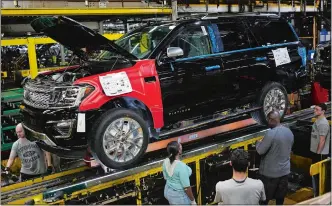  ?? LUKE SHARRETT/BLOOMBERG ?? Employees work on a Ford Expedition sports utility vehicle on the assembly line in Louisville, Ky.