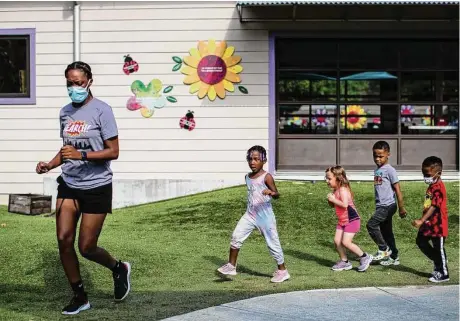  ?? Staff file photo ?? SEARCH’s House of Tiny Treasures preschool students listen to music while marching in the courtyard in 2022. SEARCH received $3 million of the $15 million the Houston Endowment granted to organizati­ons battling homelessne­ss.