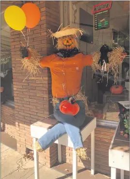  ?? PHOTOS BY KYRA GOTTESMAN— MERCURY-REGISTER ?? This jolly pumpkin-head scarecrow greeted Bird Street Vendors’ customers with open arms during the downtown scarecrow contest Friday in Oroville.