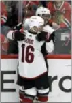  ?? THE ASSOCIATED PRESS ?? Arizona’s Anthony Duclair, top, celebrates with Max Domi after scoring a goal against the Blackhawks in Chicago. The Blackhawks won 3-1.