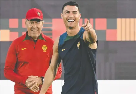  ?? PATRICIA DE MELO MOREIRA/AFP/GETTY IMAGES ?? Portugal striker Cristiano Ronaldo shares a laugh during practice at the Al Shahaniya SC training site, northwest of Doha, Qatar on Friday, the eve of his side's World Cup quarterfin­al match against Morocco. Ronaldo came off the bench in the round of 16.