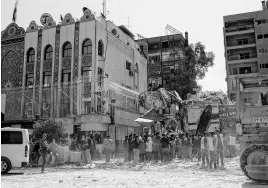  ?? REUTERS ?? Civil defence members and workers clear rubble on April 2 after a suspected Israeli strike on Monday on Iran’s consulate, adjacent to the main Iranian embassy building, which Iran said had killed seven military personnel including two key figures in the Quds Force, in the Syrian capital Damascus.