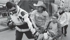  ??  ?? Left: A marathon competitor is traumatize­d. Right: Medical responders run an injured man past the finish line. At Massachuse­tts General Hospital, Alisdair Conn, chief of emergency services, said: “This is something I’ve never seen in my 25 years here.”