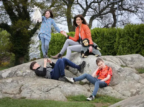  ??  ?? FAMILY TIME: Emily Hourican with her three children. Her middle child is leaving primary education, but without the graduation ceremony