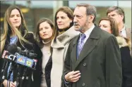  ?? Erik Trautmann / Hearst Connecticu­t Media ?? Defense attorney Jon Schoenhorn speaks to the media outside the Stamford courthouse in February as his client, Michelle Troconis, center, stands with her family.