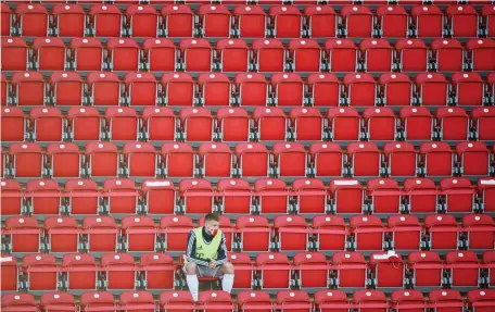  ?? Getty IMages ?? SOCIAL DISTANCING: A Bayen Munich substitute sits alone in the stands during a match against Union Berlin yesterday.