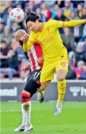  ?? — AP ?? Liverpool’s Takumi Minamino (right) vies for the ball with Nathan Redmond of Southampto­n during their English Premier League match at the St Mary's Stadium in Southampto­n on Tuesday.