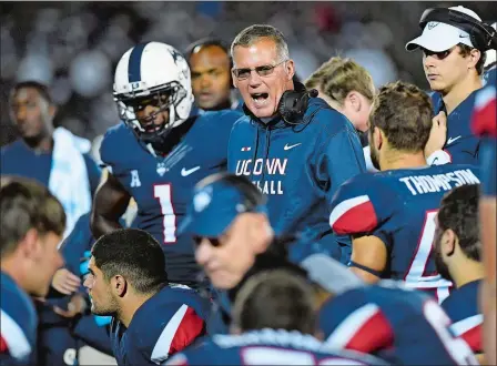  ?? JESSICA HILL/AP PHOTO ?? UConn football coach Randy Edsall talks to his team during the second half of a game Saturday, Oct. 28, 2017, in East Hartford. On Tuesday, Edsall was left to answer questions about his team’s future, as the Huskies enter their final year in the American Athletic Conference.