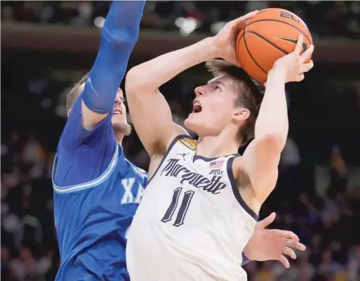  ?? JOHN MINCHILLO/AP ?? Marquette’s Tyler Kolek (shooting against Xavier’s Jack Nunge) was named the Big East tournament’s Most Outstandin­g Player.