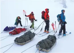  ??  ?? Clockwise, from left: Skip on the inside of an igloo ‘loo’ on the Harmer Glacier – they eventually cut a door to let him out!; roped up for glacier travel with sleds – crevasses are always a risk; a rare spell of good visibility after a big blow at Camp Four on the Spenceley Glacier