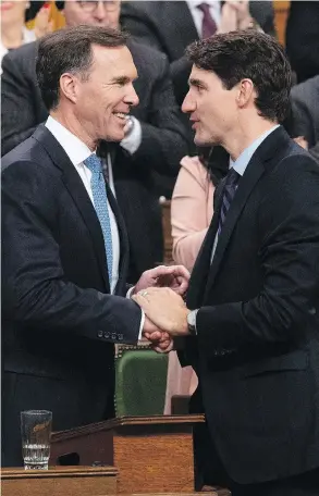  ?? ADRIAN WYLD / THE CANADIAN PRESS ?? Minister of Finance Bill Morneau and Prime Minister Justin Trudeau following the fiscal economic update in the House of Commons on Wednesday.