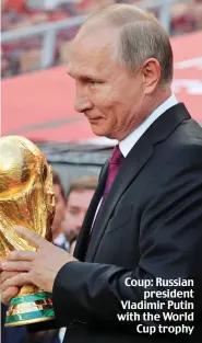  ??  ?? Coup: Russian president Vladimir Putin with the World Cup trophy