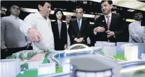  ??  ?? Duterte and Li Keqiang are presented with the scale models of the Binondo-Intramuros and Estrella Pantaleon Bridges on November 17, 2017. The projects will be built and financed by China’s grant.