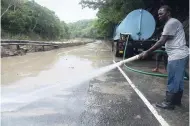  ??  ?? Yesterday, clean-up work along the Bog Walk Gorge in St Catherine was under way before it could be reopened to motorists after flooding from recent heavy rains.