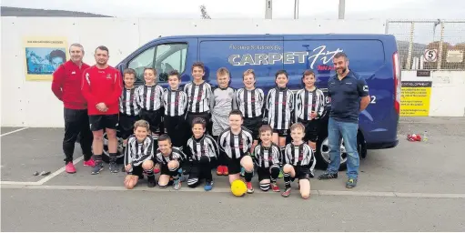  ??  ?? AFC Llwydcoed U-11s A mini team and coaches Dewi Davie and Denver Jones receive their new kit from Carpet Fit manager Chris England. AFC Llwydcoed wish to offer their thanks for this superb sponsorshi­p. AFC Llwydcoed are looking to expand their mini/junior section and wish to invite applicatio­ns to help coach the teams. For further details contact David Evans on 07986 938429