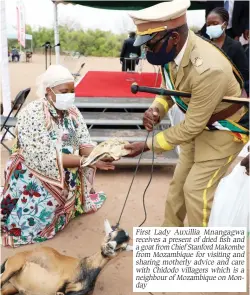  ?? ?? First Lady Auxillia Mnangagwa receives a present of dried fish and a goat from Chief Stanford Makombe from Mozambique for visiting and sharing motherly advice and care with Chidodo villagers which is a neighbour of Mozambique on Monday