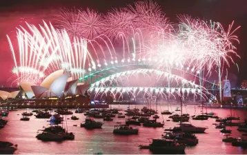  ?? DAVID GRAY/GETTY-AFP ?? New Year’s Eve fireworks light up the sky Sunday over the Opera House and Harbor Bridge in Sydney.