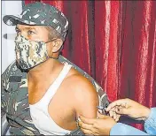  ??  ?? A CRPF soldier receives gets vaccinated against Covid-19, in Jammu on Friday.