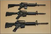  ?? RICH PEDRONCELL­I — AP PHOTO, FILE ?? Three variations of the AR-15assault rifle are displayed at the California Department of Justice in Sacramento, California will give gun owners more time to register their legal assault weapons under a settlement Thursday.