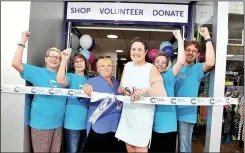  ??  ?? Hinckley’s new Cancer Research store being opened by store manager Alison Davis, centre left, and cancer patient Clare Collins, centre right