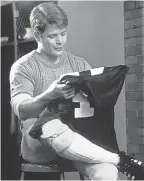  ??  ?? Notre Dame walk-on Rudy Ruettiger (Sean Astin) puts on his game jersey in “Rudy.” FATHOM EVENTS