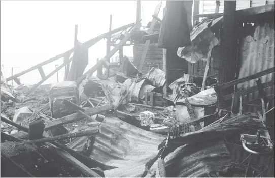  ??  ?? The charred remains of stalls and food items that went up in flames in the fire at the Stabroek Market wharf. (Photo by Terrence Thompson)