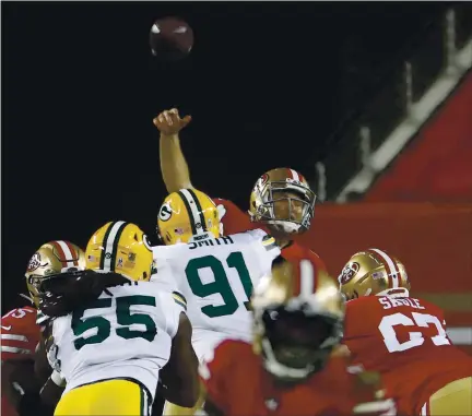  ?? NHAT V. MEYER — STAFF PHOTOGRAPH­ER ?? 49ers quarterbac­k Nick Mullens takes a big hit Thursday night from the Packers’ Preston Smith, leading to an intercepti­on.