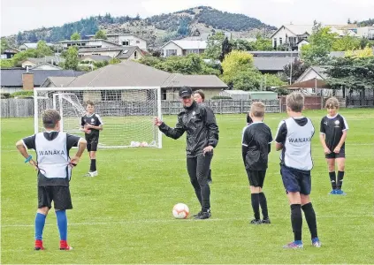  ?? PHOTO: KERRIE WATERWORTH ?? Ole ole ole . . . Ole Football Academy Technical Director Ben Sippola coaches a group of youngsters at the Wanaka Football Club on Monday during the academy’s fourday camp.