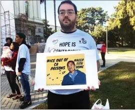  ?? PHOTOS BY DON THOMPSON — THE ASSOCIATED PRESS ?? Connor Gorman of Davis joins a rally on behalf of Cambodian refugee Tith Ton, who is awaiting parole from a murder conviction but could be deported to Cambodia, outside the Capitol in Sacramento on Friday.