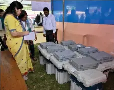  ?? AFP ?? Indian election officials check electronic voting machines at a distributi­on centre in Bokakhat, in India’s Assam state