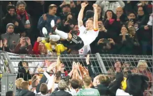  ?? CHRISTIAN CHARISIUS/DPA/AFP ?? Teammates throw Lukas Podolski in the air after the friendly against England, Podolski’s last match for Germany, in Dortmund on Wednesday.