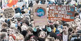  ?? MICHAEL SOHN/AP ?? Young people attend a Fridays for Future protest in Berlin, one of several worldwide.