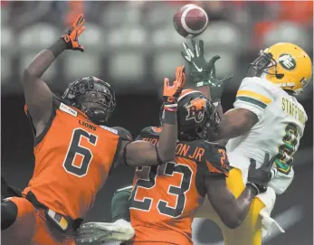  ?? CP PHOTO BY DARRYL DYCK ?? B.C. Lions’ T.J. Lee (6) prevents Edmonton Eskimos’ Kenny Stafford, back right, from making the reception as B.C.’s Anthony Thompson (23) defends during CFL football action in Vancouver on Thursday.