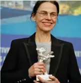  ??  ?? German director Angela Schanelec poses with the Silver Bear for best director for the film “Ich war zu Hause, aber...” (I was at home, but).