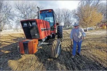  ?? (AP/Santa Fe New Mexican/Luis Sanchez Saturno) ?? Paul Skrak, owner of Hidalgo Farms in Pena Blanca, N.M., warms up his tractor Jan. 20 to prepare one of his fields for laser leveling. Skrak is adopting new growing methods to withstand drought.