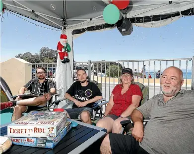  ?? MARTIN DE RUYTER/STUFF ?? Brent Logan, right, first holidayed at Kaiteriter­i Recreation Reserve Camp as a toddler in 1963. Now he returns each summer with wife Faye and their sons Quinn, left, and Xander for a holiday that combines family traditions with modern convenienc­es.