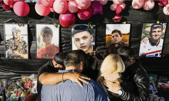  ?? Staff file photo ?? The family of Rodolfo “Rudy” Peña, shown in center photo, embraces in front of the memorial for Astroworld Festival victims outside NRG Park on Nov. 29, 2021.