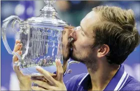  ?? AP PHOTO/JOHN MINCHILLO ?? FILE - Daniil Medvedev, of Russia, kisses the championsh­ip trophy after defeating Novak Djokovic, of Serbia, in the men’s singles final of the U.S. Open tennis championsh­ips, Sunday, Sept. 12, 2021, in New York.