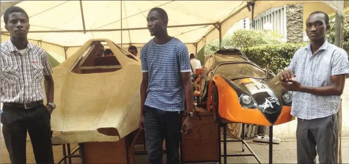  ??  ?? L-R: Emmanuel Chukwuma, Qudus Adegbuji and Reuben Akande, standing with the two vehicles under constructi­on Auto Deluxe or Urban Concept and Autonov 3 at the UNILAG 2016 Convocatio­n Exhibition