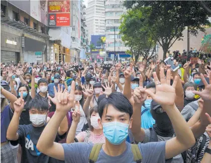  ?? Photo / AP ?? Protesters against the new national security law march and gesture with five fingers, signifying the “Five demands — not one less”.