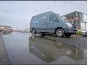  ?? (AP/Michael Nagle) ?? Amazon vans and trailers are parked outside of a delivery station in Newark, N.J., in October.