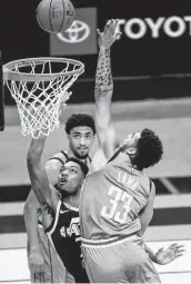  ?? Mark Mulligan / Staff photograph­er ?? Rockets rookie Anthony Lamb (33) gets in on the one-sided action in the fourth quarter Wednesday.