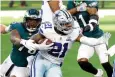  ?? AP Photo/Ron Jenkins ?? ■ Philadelph­ia Eagles defensive end Vinny Curry (75) reaches out to stop Dallas Cowboys running back Ezekiel Elliott (21) in the first half Sunday in Arlington, Texas.